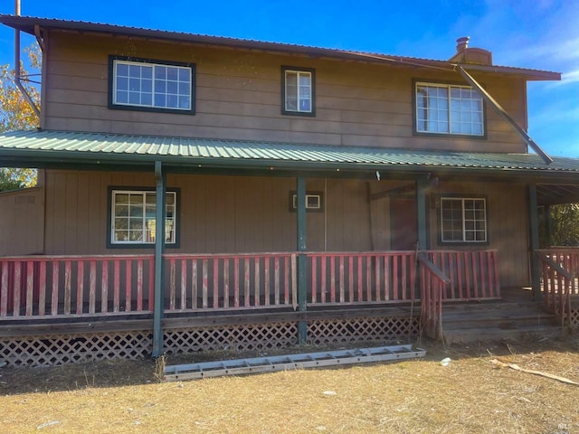 back of property featuring a porch