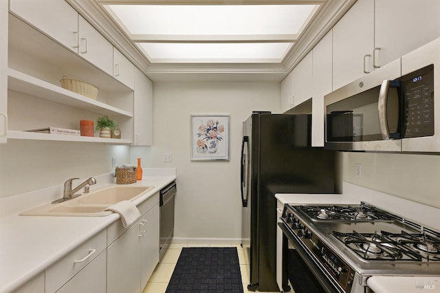 kitchen featuring sink, dishwasher, range with gas stovetop, white cabinets, and light tile patterned flooring