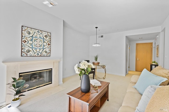 living room featuring light colored carpet and a fireplace