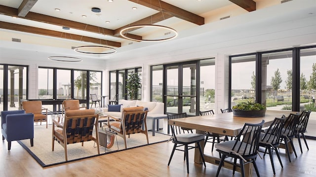 sunroom with beam ceiling and french doors