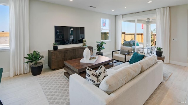 living room featuring ceiling fan and light wood-type flooring