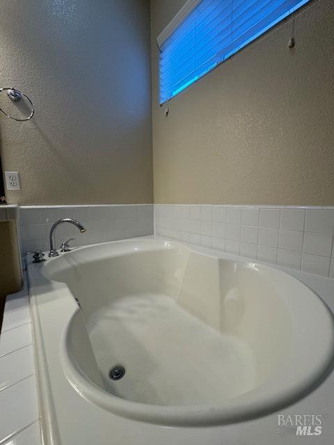 bathroom featuring a tub to relax in