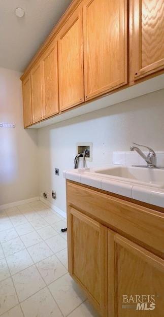 laundry area with cabinets, hookup for a washing machine, electric dryer hookup, and sink