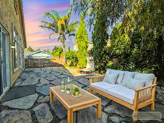 patio terrace at dusk featuring outdoor lounge area