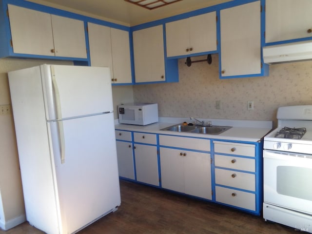 kitchen featuring dark hardwood / wood-style floors, white appliances, sink, and range hood