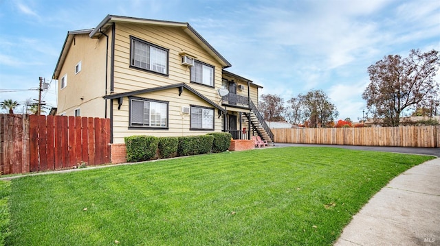 exterior space featuring a lawn and a wall mounted air conditioner