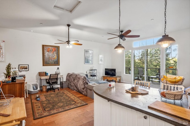 kitchen with decorative light fixtures, light hardwood / wood-style floors, white cabinetry, and ceiling fan