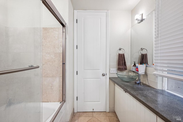 bathroom featuring shower / bath combination with glass door, tile patterned floors, and vanity