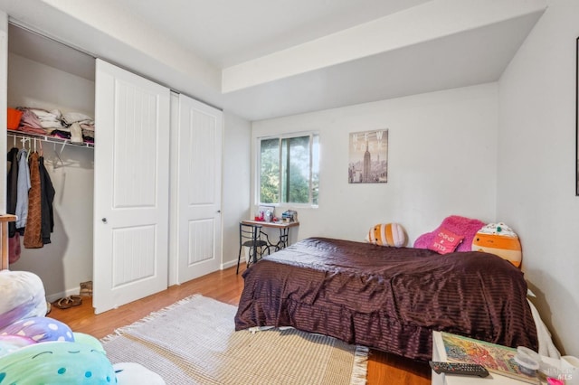 bedroom with hardwood / wood-style floors and a closet