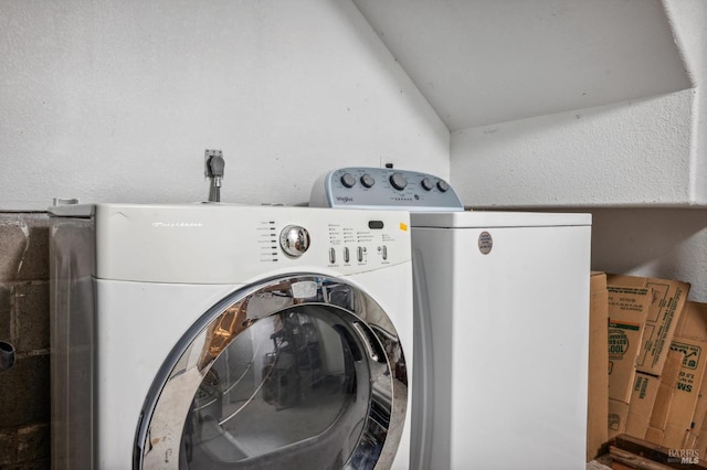 clothes washing area featuring separate washer and dryer