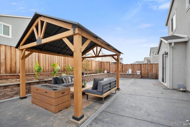 view of patio featuring a gazebo and an outdoor living space with a fire pit