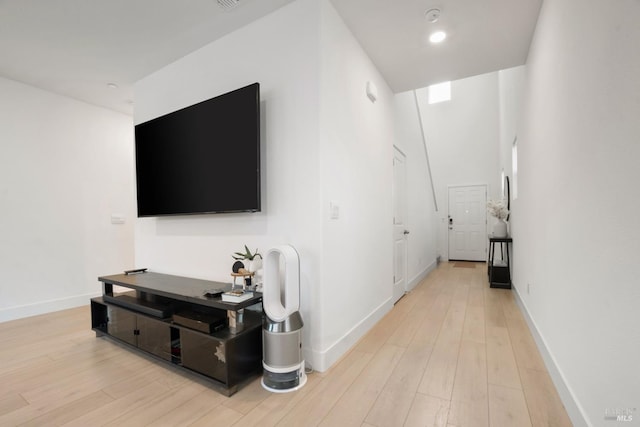 corridor with light hardwood / wood-style flooring