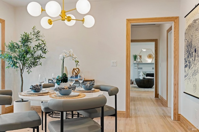 dining room featuring an inviting chandelier and light hardwood / wood-style flooring