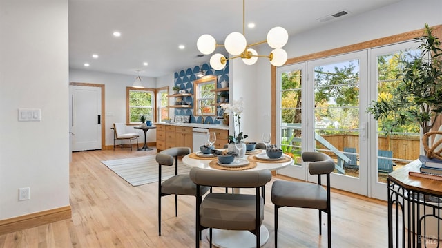 dining area featuring light hardwood / wood-style floors and a chandelier