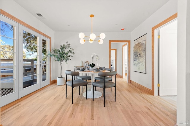 dining room featuring light hardwood / wood-style floors and a chandelier