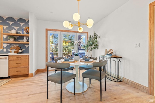 dining area featuring light hardwood / wood-style floors and a notable chandelier