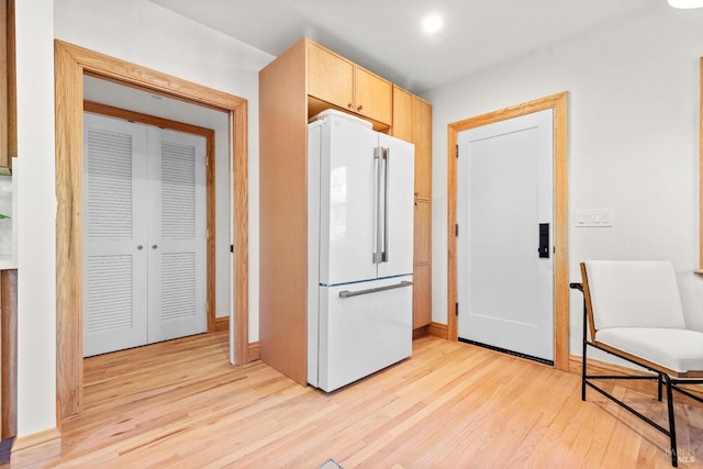 kitchen featuring white fridge, light brown cabinetry, and light hardwood / wood-style flooring