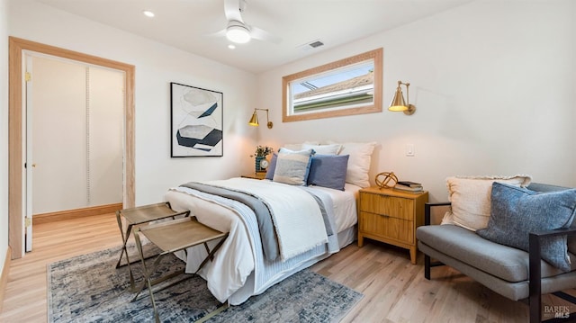 bedroom with ceiling fan and light hardwood / wood-style flooring