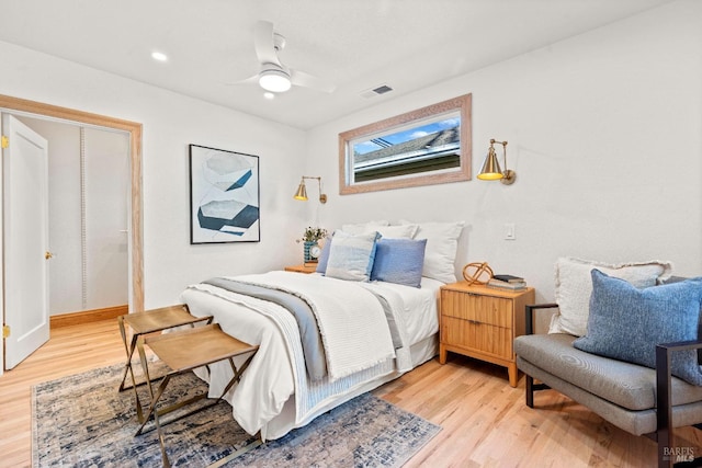 bedroom with ceiling fan and light hardwood / wood-style floors