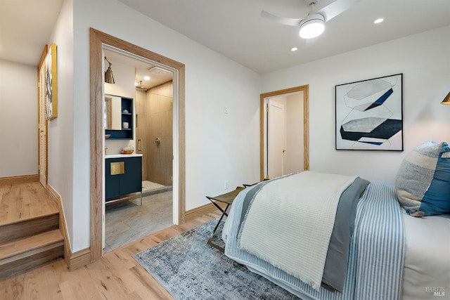 bedroom featuring ensuite bath, ceiling fan, and light hardwood / wood-style floors