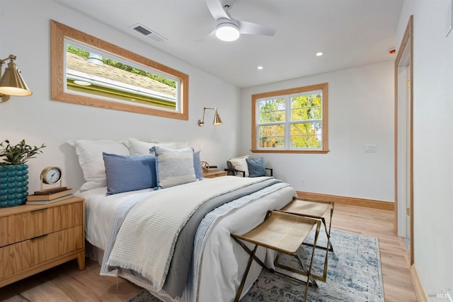 bedroom with light hardwood / wood-style flooring and ceiling fan