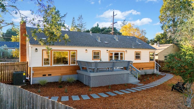 rear view of property with central AC unit and a deck