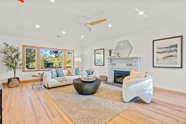 living room featuring ceiling fan and light hardwood / wood-style flooring