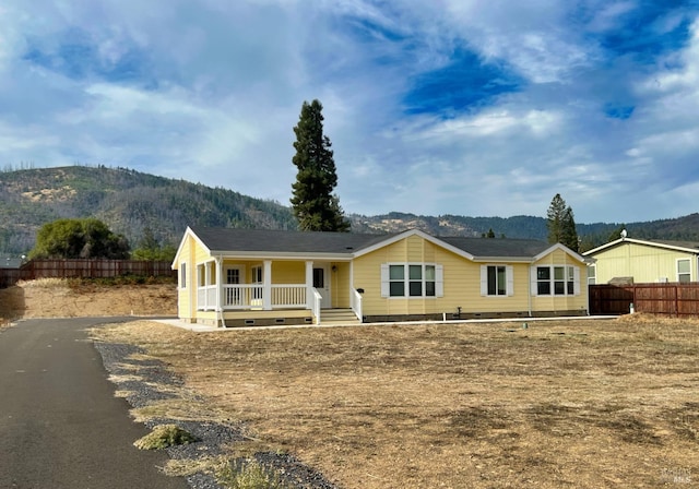 view of front of house featuring a mountain view and a porch