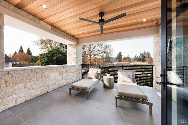 view of patio featuring ceiling fan and a balcony