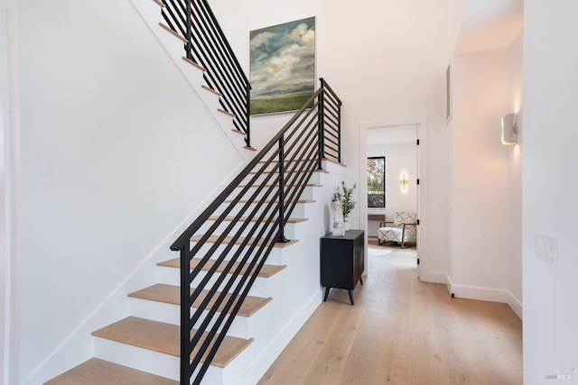 stairs featuring hardwood / wood-style floors