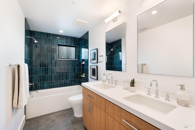 full bathroom with toilet, vanity, and tiled shower / bath