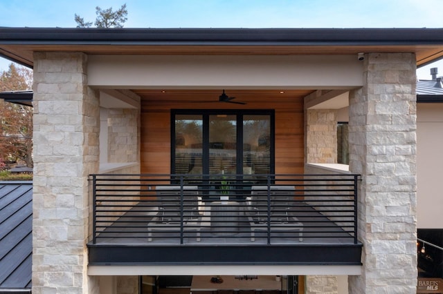 entrance to property with ceiling fan and a balcony