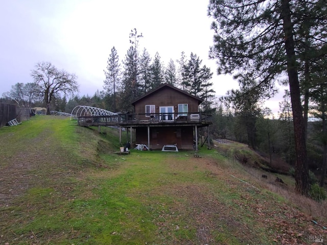 back of house with a yard and a deck