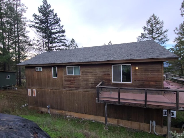 rear view of property featuring a deck