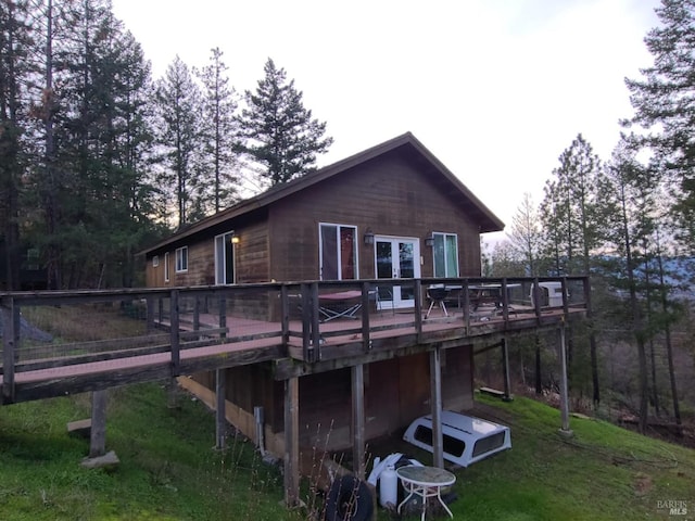 rear view of property featuring a deck