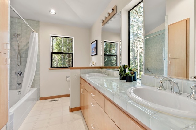 bathroom featuring shower / bath combo with shower curtain, vanity, and lofted ceiling