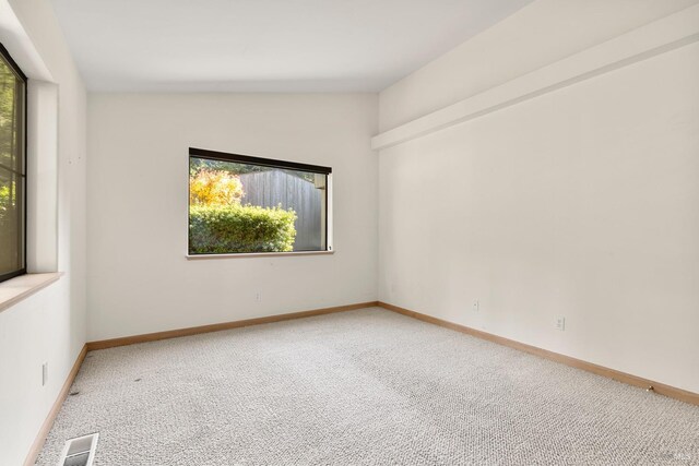 bedroom featuring lofted ceiling and light carpet