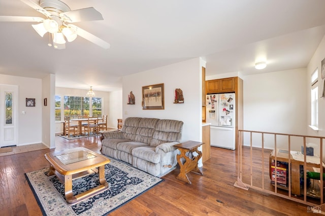 living room featuring ceiling fan and dark hardwood / wood-style flooring