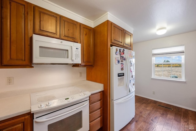 kitchen with dark wood-type flooring and white appliances