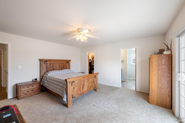 bedroom with ceiling fan, a spacious closet, light carpet, and a closet