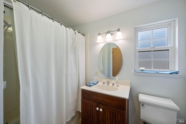 bathroom featuring vanity, a shower with curtain, and toilet