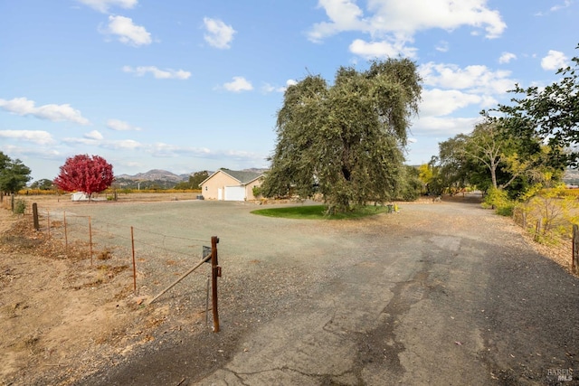 view of street with a rural view and driveway