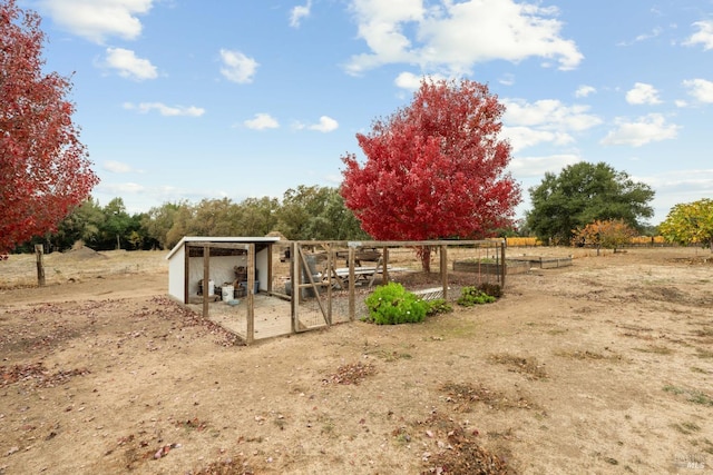 exterior space featuring an outdoor structure and a rural view