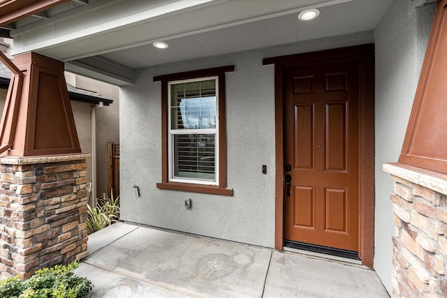 view of exterior entry with a porch