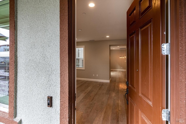 corridor with dark hardwood / wood-style flooring