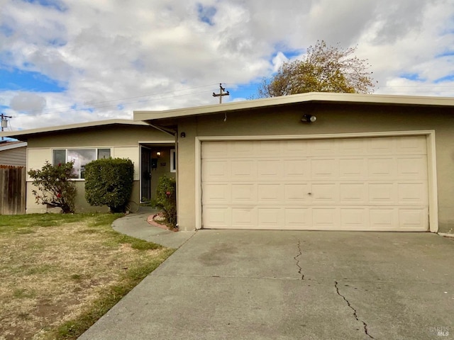 single story home featuring a garage and a front lawn