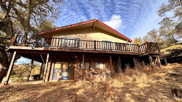 back of property with a wooden deck