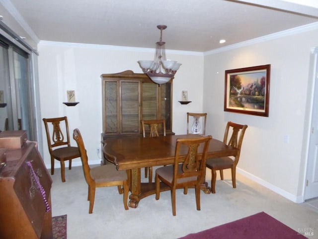 dining area featuring ornamental molding, light carpet, and a chandelier