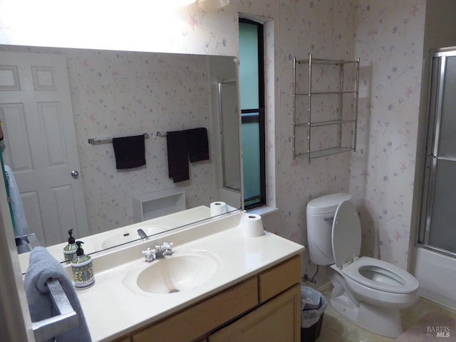 full bathroom with vanity, toilet, and bath / shower combo with glass door