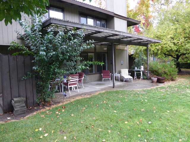 rear view of house with a patio area and a yard